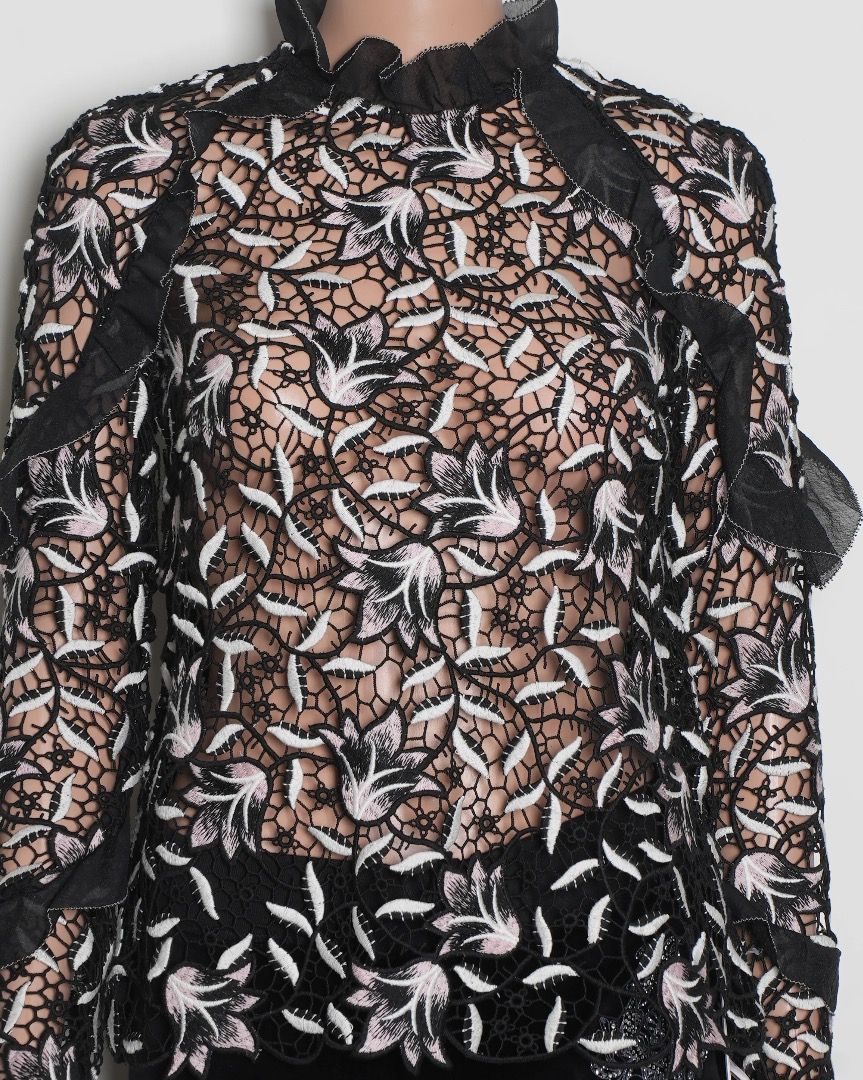 Black Lace Top with Floral Embroidery (Category: Blouses) located in Singapore. Submitted by malaikahasan (Listing ID 1379384365, Image 2). Description: Elegant black lace top featuring intricate floral embroidery. It has long sleeves and a high neckline with ruffle detailing. The top appears to be in excellent condition, perfect for a special occasion or to elevate your everyday style..