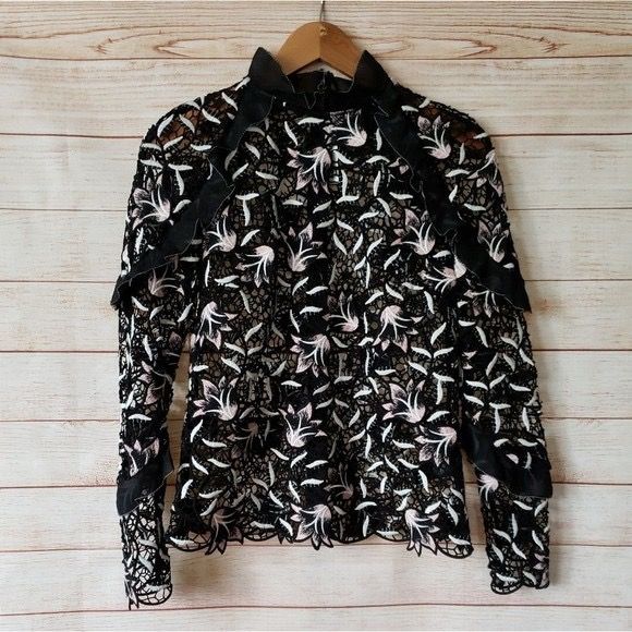 Black Lace Top with Floral Embroidery (Category: Blouses) located in Singapore. Submitted by malaikahasan (Listing ID 1379384365, Image 3). Description: Elegant black lace top featuring intricate floral embroidery. It has long sleeves and a high neckline with ruffle detailing. The top appears to be in excellent condition, perfect for a special occasion or to elevate your everyday style..