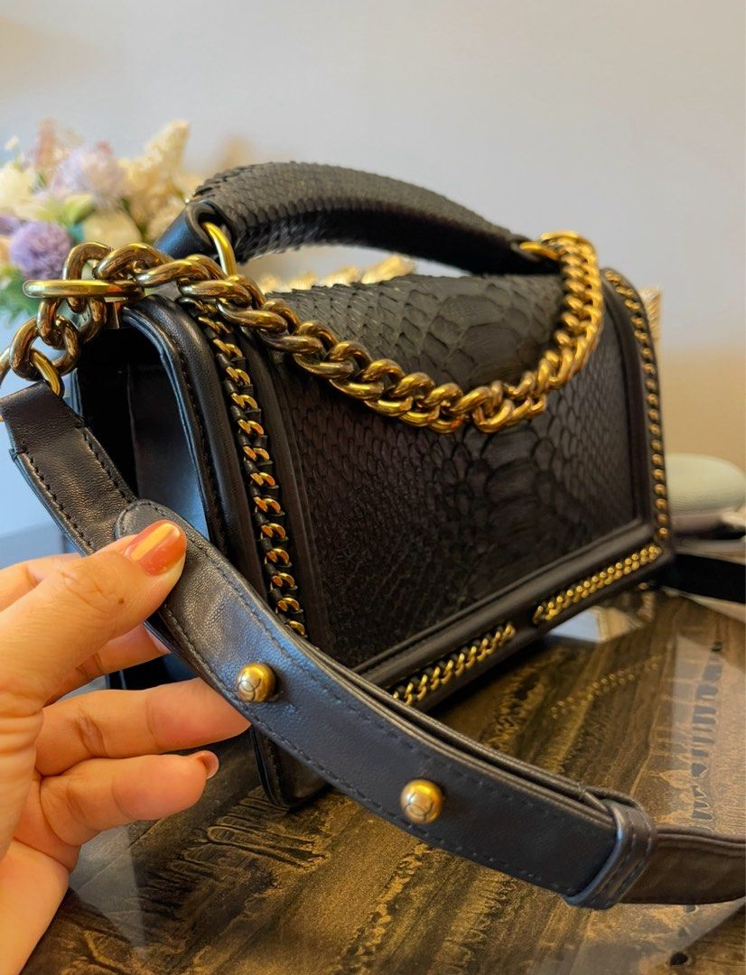 Black Python bag (Category: Bags & Wallets) located in Singapore. Submitted by aceirus (Listing ID 1379483832, Image 1). Description: leather bag. Features gold chain detailing and hardware. Includes a top handle and a shoulder strap. Interior shows minimal signs of wear. A beautiful and timeless piece..
