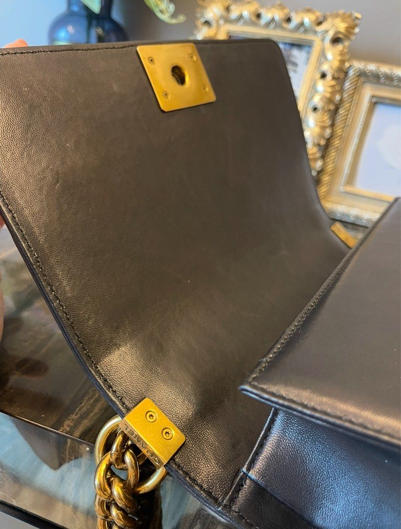 Black Python bag (Category: Bags & Wallets) located in Singapore. Submitted by aceirus (Listing ID 1379483832, Image 3). Description: leather bag. Features gold chain detailing and hardware. Includes a top handle and a shoulder strap. Interior shows minimal signs of wear. A beautiful and timeless piece..