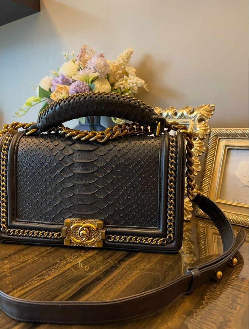 Black Python bag (Category: Bags & Wallets) located in Singapore. Submitted by aceirus (Listing ID 1379483832, Image 2). Description: leather bag. Features gold chain detailing and hardware. Includes a top handle and a shoulder strap. Interior shows minimal signs of wear. A beautiful and timeless piece..