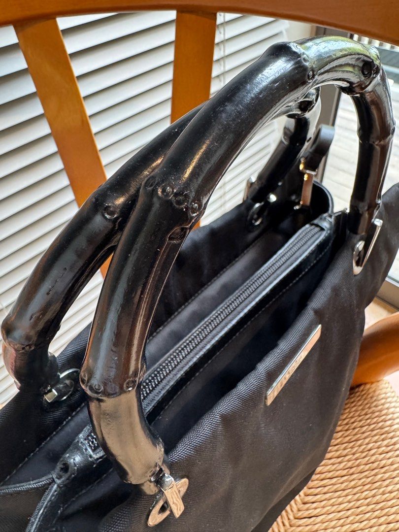 Gucci Bamboo Handle Tote Bag (Category: Bags & Wallets) located in Singapore. Submitted by frangipani77 (Listing ID 1379424349, Image 1). Description: Authentic Gucci tote bag with bamboo handles. Features a black nylon exterior and a detachable shoulder strap. The interior includes a zippered pocket and a Gucci label. Made in Italy..