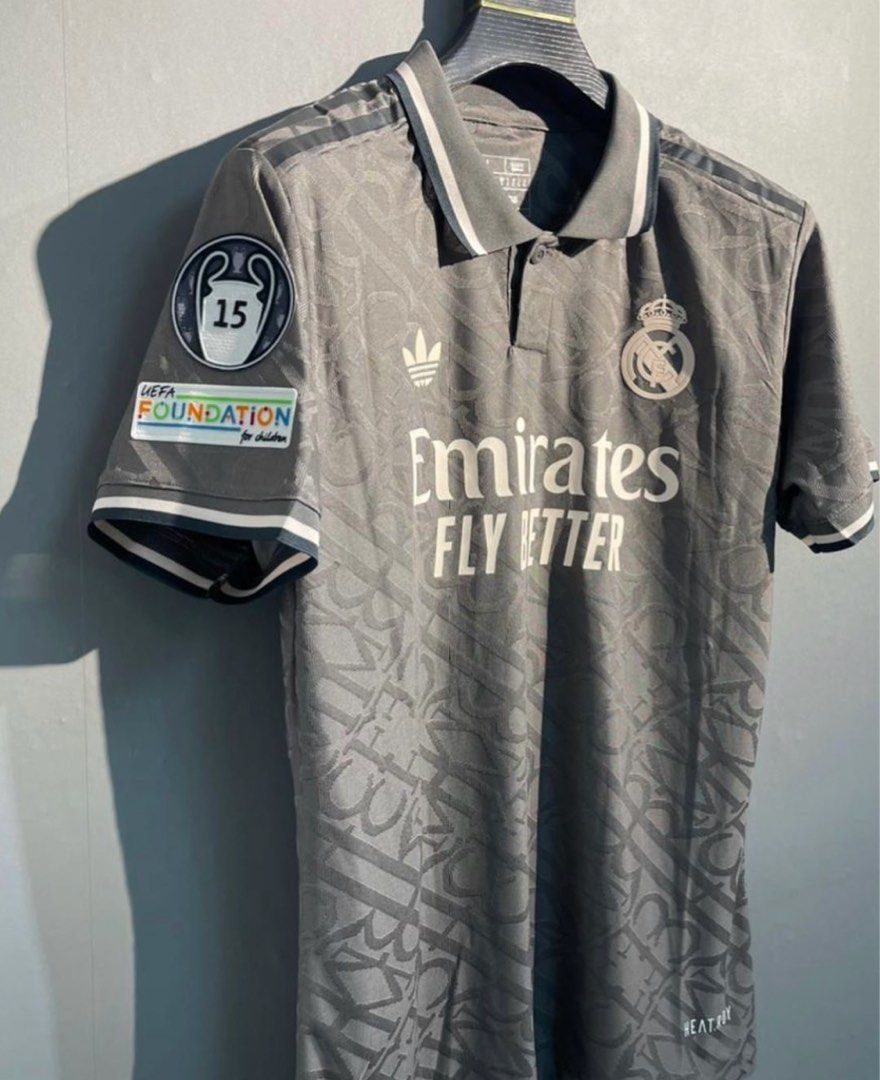 Real Madrid third kit Mbappe UCL version (Category: Activewear) located in Singapore. Submitted by footyjerseys (Listing ID 1379387136, Image 2). Description: Authentic Real Madrid jersey, featuring a unique Dior design. This jersey is a size L and features Mbappe's name and number on the back. It includes the Adidas logo and Emirates Fly Better sponsor. Perfect for fans and collectors..