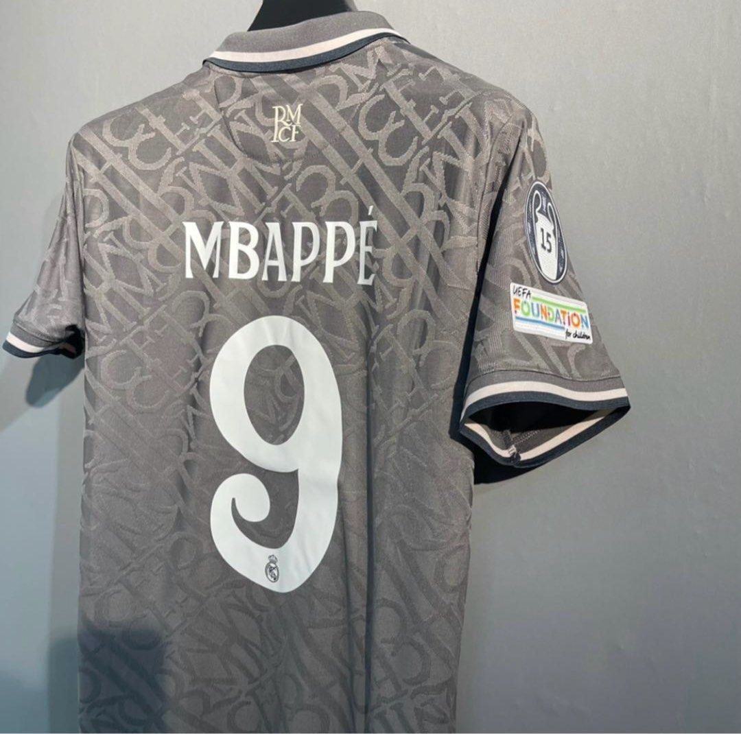 Real Madrid third kit Mbappe UCL version (Category: Activewear) located in Singapore. Submitted by footyjerseys (Listing ID 1379387136, Image 3). Description: Authentic Real Madrid jersey, featuring a unique Dior design. This jersey is a size L and features Mbappe's name and number on the back. It includes the Adidas logo and Emirates Fly Better sponsor. Perfect for fans and collectors..