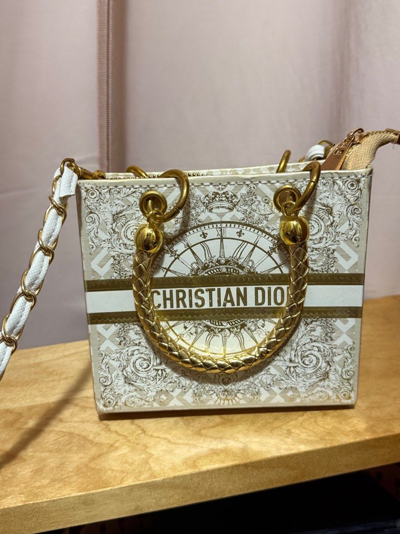 Upcycle Christian Dior Mini Tote Bag (Category: Bags & Wallets) located in Singapore. Submitted by pinkybaby19 (Listing ID 1379408791, Image 1). Description: Upcycle Christian Dior mini tote bag made out of authentic Dior paper bag & laminated. Features a gold chain strap and gold hardware. The bag has a zip closure and a spacious interior. Perfect for carrying essentials. Bought from Bangkok. RTP $95. Used once only .