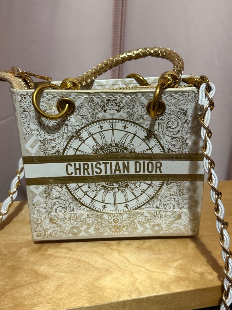 Upcycle Christian Dior Mini Tote Bag (Category: Bags & Wallets) located in Singapore. Submitted by pinkybaby19 (Listing ID 1379408791, Image 2). Description: Upcycle Christian Dior mini tote bag made out of authentic Dior paper bag & laminated. Features a gold chain strap and gold hardware. The bag has a zip closure and a spacious interior. Perfect for carrying essentials. Bought from Bangkok. RTP $95. Used once only .