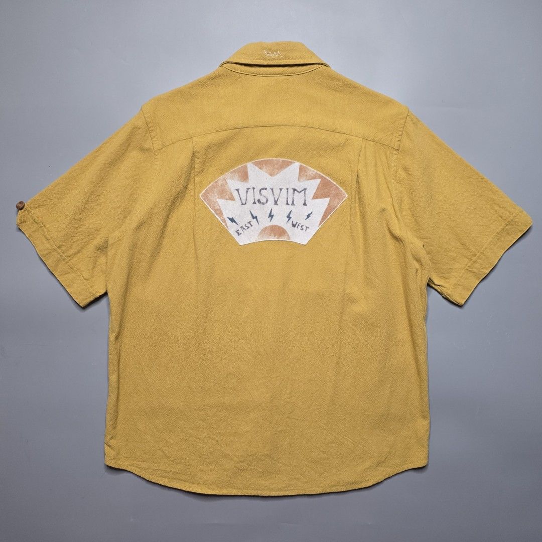 Visvim - SS18 Ellas Shirt - Mustard (Category: Formal Shirts) located in Malabon City. Submitted by buynflex (Listing ID 1379441729, Image 2). Description: Visvim - SS18 Ellas Shirt S/S E. W. - Mustard Size 2 (W 22 X L 28.5 Inches) Gently Used Very Good Condition Product Information Short-sleeved shirt made from linen-silk-cotton blend fabric. One wash Hand stitched detail Original patch detail Original bamboo buttons.