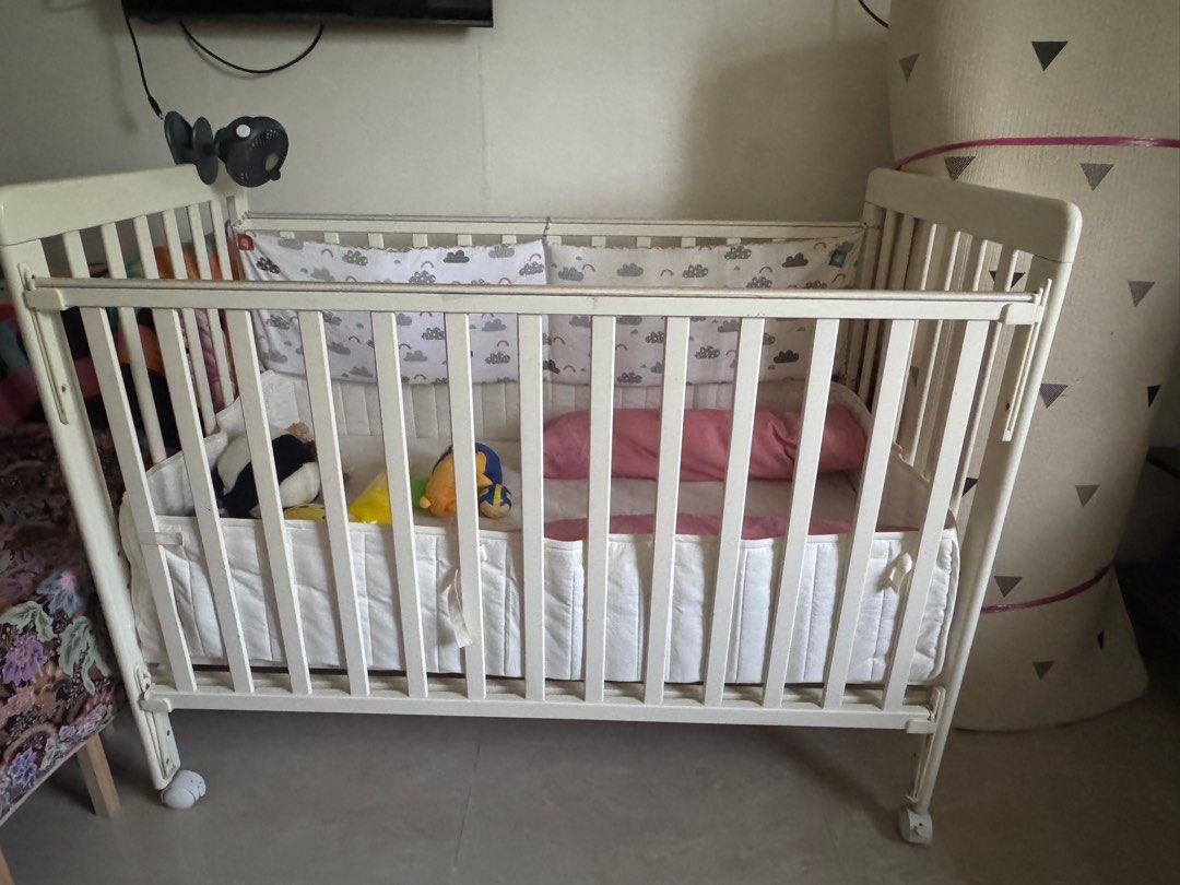Baby Cot (Comes with guard and pillow ) (Category: Cots & Cribs) located in Singapore. Submitted by songz1978 (Listing ID 1379566010, Image 1). Description: Put at mother in law house for visiting purpose. Baby no longer need it. Bed guard and etc included .