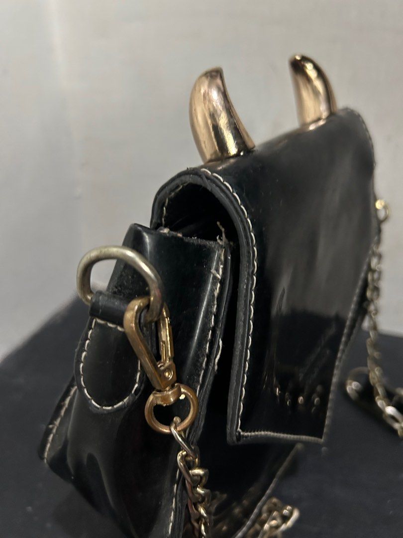 Black Horned Crossbody Bag (Category: Cross-body Bags) located in Quezon City. Submitted by rinepryno (Listing ID 1379575605, Image 3). Description: RFS: not used anymore with noticeable flaws on the hardware and cover flap but still in good condition.