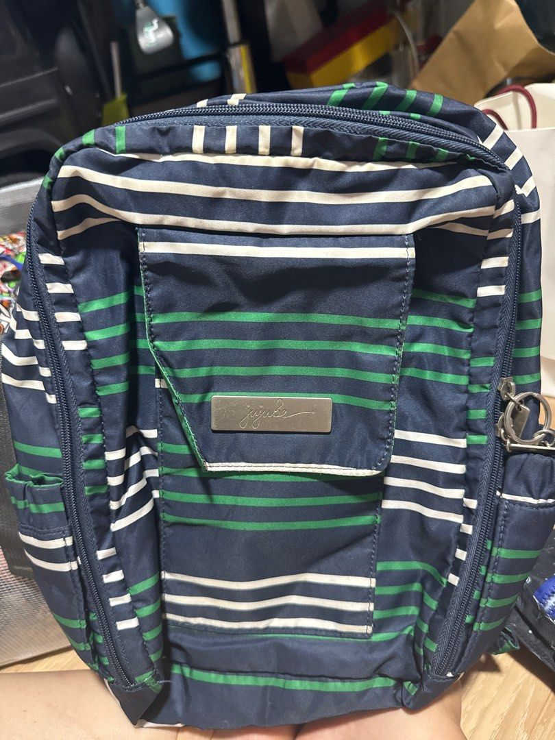 JuJuBe minibe Diaper Bag - Navy Stripe (Category: Diaper Bags & Wetbags) located in Singapore. Submitted by seikayan (Listing ID 1379665681, Image 1). Description: Stylish and functional JuJuBe Be Right Back diaper bag in a navy stripe pattern. Features multiple compartments for organization, including insulated bottle pockets. Comfortable backpack straps and a grab handle. In good condition, with minimal signs of wear..