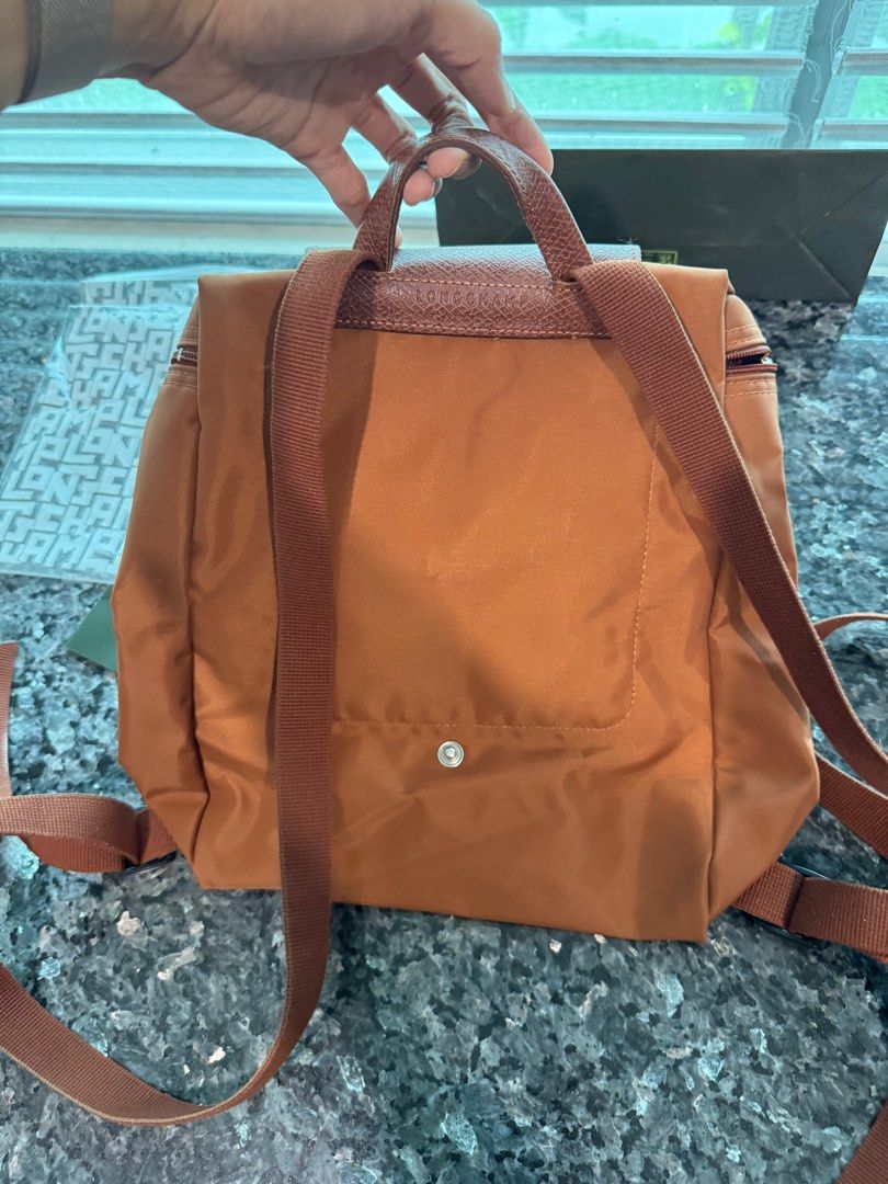 Longchamp Le Pliage Original M Backpack (Category: Luxury Bags & Wallets) located in San Juan City. Submitted by yannaaabanana (Listing ID 1379607575, Image 3). Description: Brand: Longchamp Color: brown Size: medium backpack Guaranteed authentic, purchased in Rustan’s for php 9,500. Complete inclusions, in original packaging. Shipping c/o buyer, pick up in San Juan.