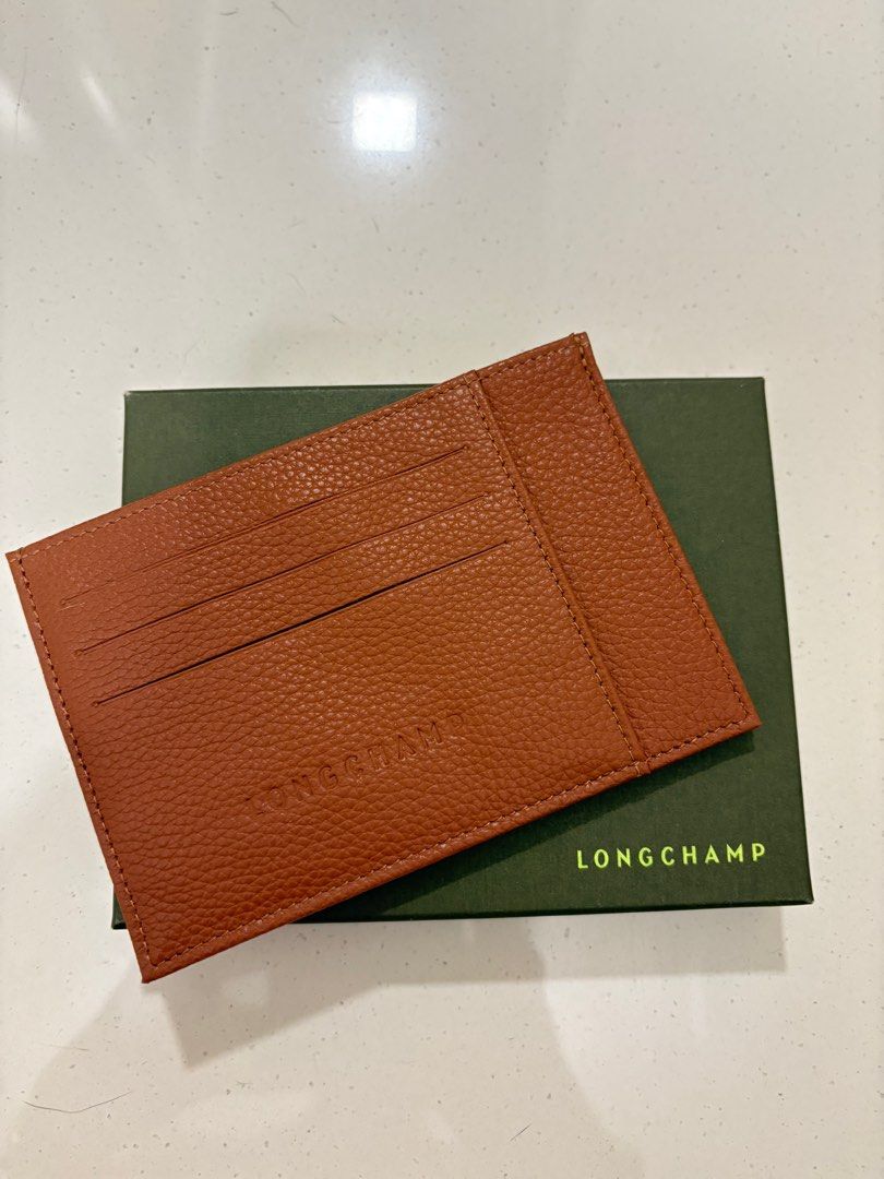 Longchamp Leather Card Holder - Brown (Category: Bags & Wallets) located in Singapore. Submitted by bbhuat (Listing ID 1379631581, Image 3). Description: Brand new Longchamp card holder. Made of textured leather. Comes with original box. Features multiple card slots for easy organization. A stylish and practical accessory for everyday use..