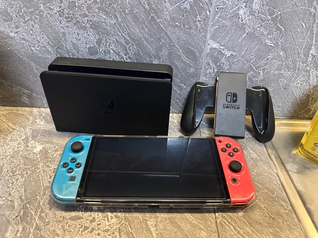 NINTENDO SWITCH OLED (Category: Nintendo) located in Santa Rosa. Submitted by jmcan (Listing ID 1379709990, Image 3). Description: RUSH RUSH RUSH NINTENDO SWITCH OLED with Box With extra joy con 3 games GTA V, NBA 2k25 (new binuksan lang pero di nalaro) IT TAKES TWO HARD CASE CASE Extra glass film Good as new Lady Owned 14k asking price slightly nego! Meet Up Cabuyao to Santa Rosa Can do lalamove or lbc (shoulder fee of buyer) Unli Check for meet