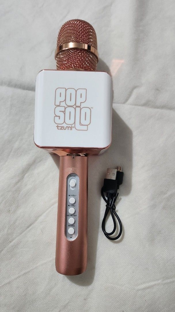 Pop Solo Bluetooth Karaoke Microphone (Category: Microphones) located in Marikina City. Submitted by mgfc926 (Listing ID 1379559953, Image 2). Description: This image displays the Tzumi PopSolo Wireless Bluetooth Karaoke Microphone. S Product: Tzumi PopSolo Wireless Bluetooth Karaoke Microphone. Features: It includes a built-in retractable smartphone holder and connects via Bluetooth for karaoke. Compatibility: Works with most karaoke apps and Yo