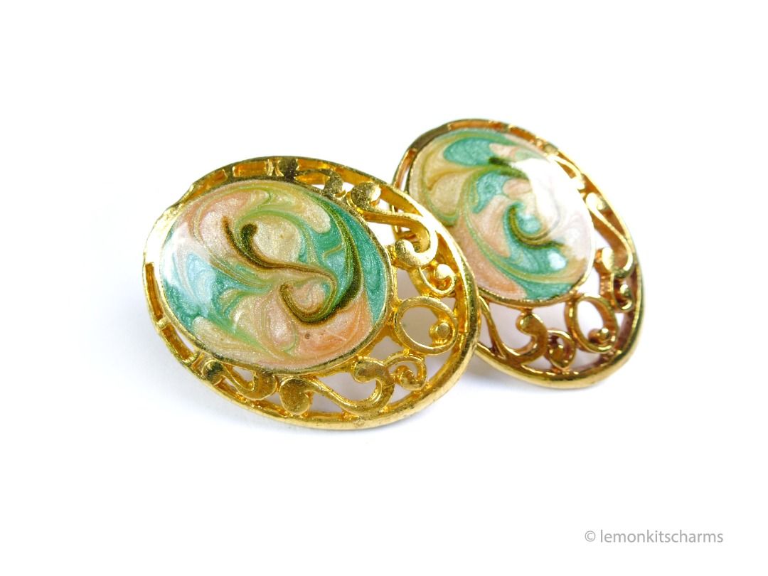 Vintage 1980s Peach Green Marbling Enamel Pierced Earrings, er2688-ci (Category: Earrings) located in Singapore. Submitted by lemonkitscharms (Listing ID 1379695845, Image 1). Description: Vintage 1980s Peach Green Marbled Enamel Earrings, for pierced ears. A dark streak and a bit of greyish base revealing on the post on back of one earring. Norma darkening on goldtone from age. Overall good condition, not for fussies. One of the earring's edge i