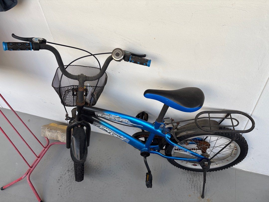 Happy Kids Blue Bicycle with Basket (Category: Bicycles) located in Singapore. Submitted by sekarbl86849 (Listing ID 1384051946, Image 1). Description: - Used Happy Kids bicycle - Good condition - Features front basket and rear rack - Suitable for young children - Minor wear and tear (see photos) - Perfect for learning to ride or casual use.