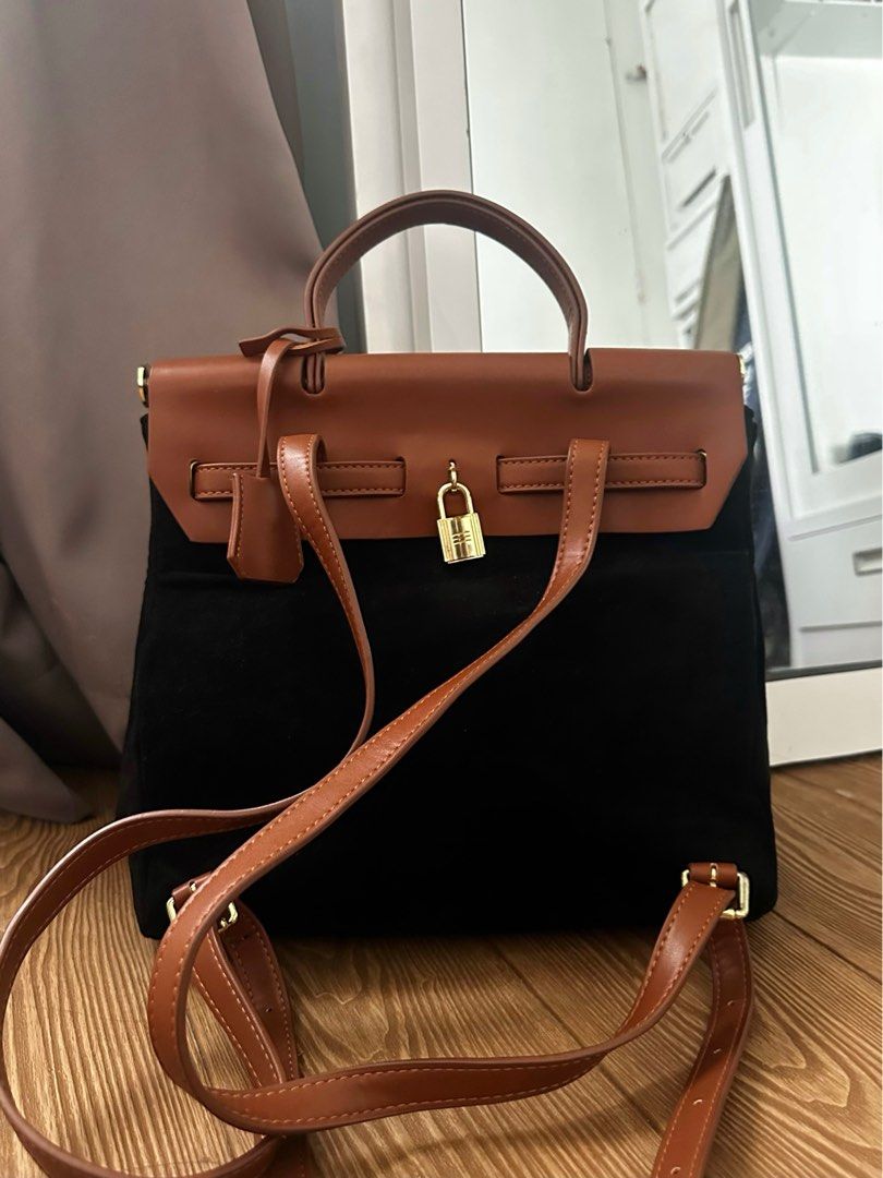 MCMIKÓ Hermes-like Backpack (Category: Luxury Bags & Wallets) located in San Pablo. Submitted by jornalensy (Listing ID 1384219764, Image 2). Description: - Black suede body - Smooth brown leather flap and straps - Functional gold padlock with keys - 1 Zipper & 2 Pockets inside - Used personally and handled with care - Can be worn as a backpack or carried by hand - Already low price for the quality and condition RFS: Decluttering .