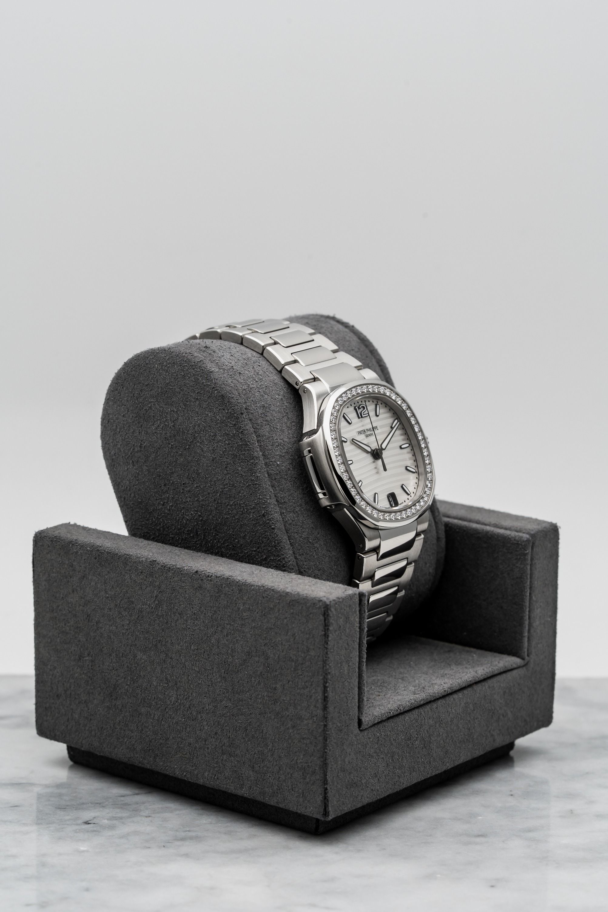 Patek Philippe Nautilus 7018/1A-001 – Ladies White Dial, Diamond Bezel • Watch Only (Category: Watches) located in Singapore. Submitted by timetells (Listing ID 1384104585, Image 3). Description: Brand: Patek Philippe Model: Nautilus Reference Number: 7018/1A-001 Year: Unknown Case Size: 33.6mm Case: Stainless Steel Dial: Silvery White with Horizontal Embossing & Date at 6 Strap: Stainless Steel Bracelet with Nautilus Folding Clasp Movement: Auto
