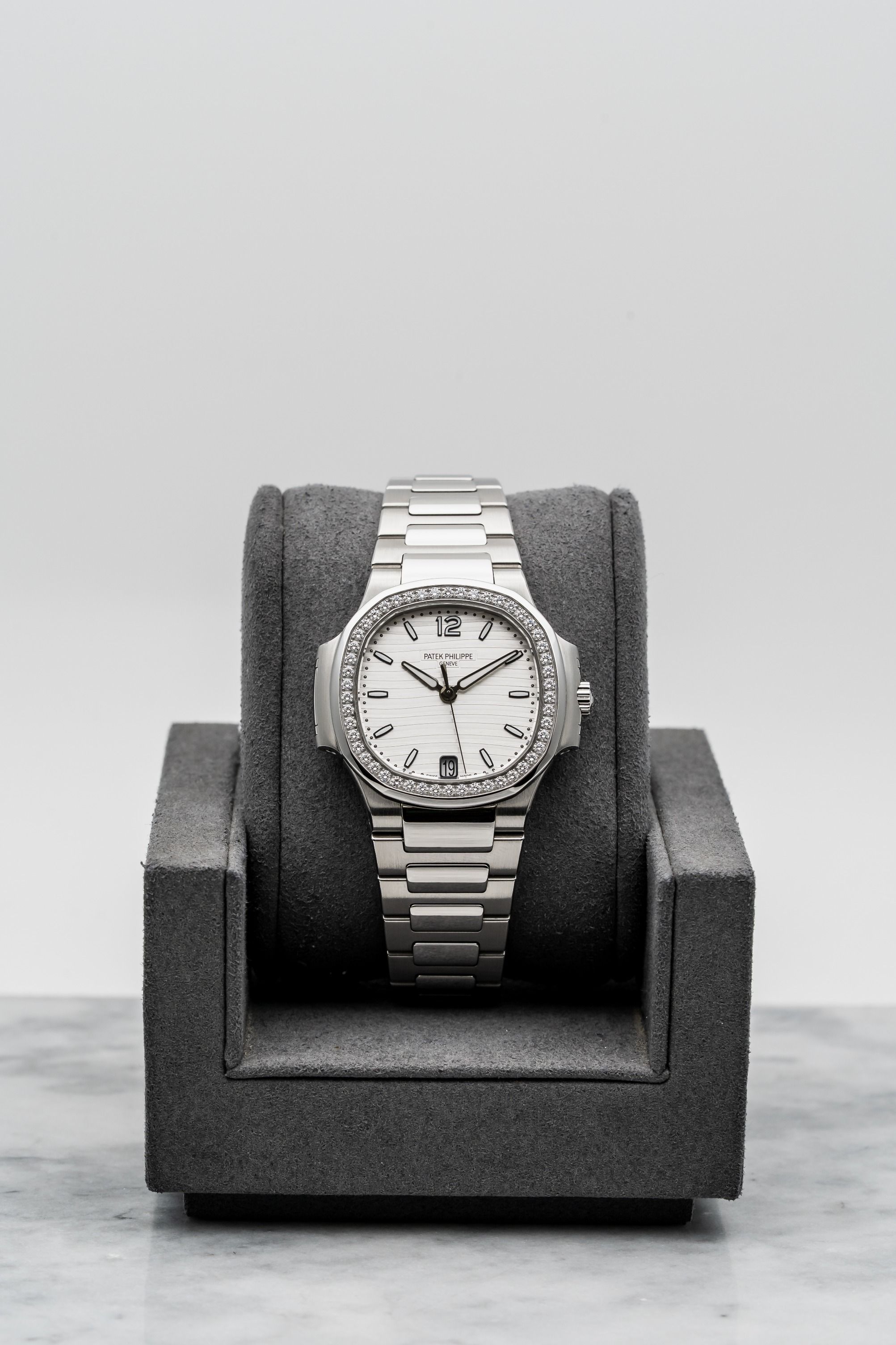 Patek Philippe Nautilus 7018/1A-001 – Ladies White Dial, Diamond Bezel • Watch Only (Category: Watches) located in Singapore. Submitted by timetells (Listing ID 1384104585, Image 1). Description: Brand: Patek Philippe Model: Nautilus Reference Number: 7018/1A-001 Year: Unknown Case Size: 33.6mm Case: Stainless Steel Dial: Silvery White with Horizontal Embossing & Date at 6 Strap: Stainless Steel Bracelet with Nautilus Folding Clasp Movement: Auto