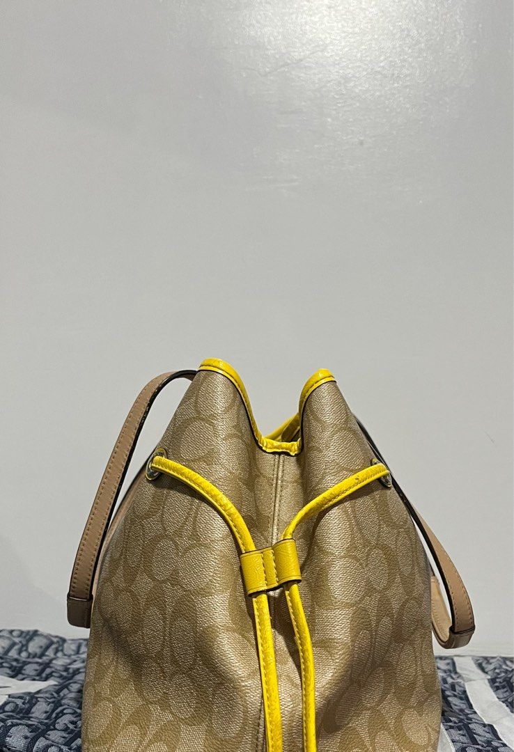 COACH SIGNATURE STRIPE DRAWSTRING CARRYALL (Category: Luxury Bags & Wallets) located in San Fernando. Submitted by gemsfndr (Listing ID 1384095826, Image 3). Description: Guaranteed Authentic With visible flaws sa front, but overall still in good condition With provided dustbag and Coach paperbag Slightly Negotiable ✨.