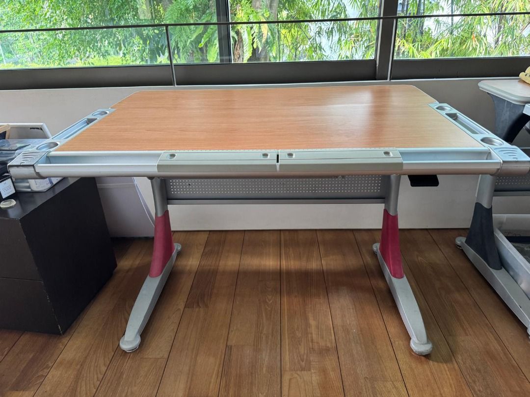 Adjustable Study Table (Category: Tables & Sets) located in Singapore. Submitted by nic.oleeeee (Listing ID 1385843192, Image 2). Description: - Great condition - Features a wooden tabletop - Adjustable height settings (55cm-75cm) - Suitable for kids and adults - Perfect for studying or working from home - Length 113cm, Depth 83cm.
