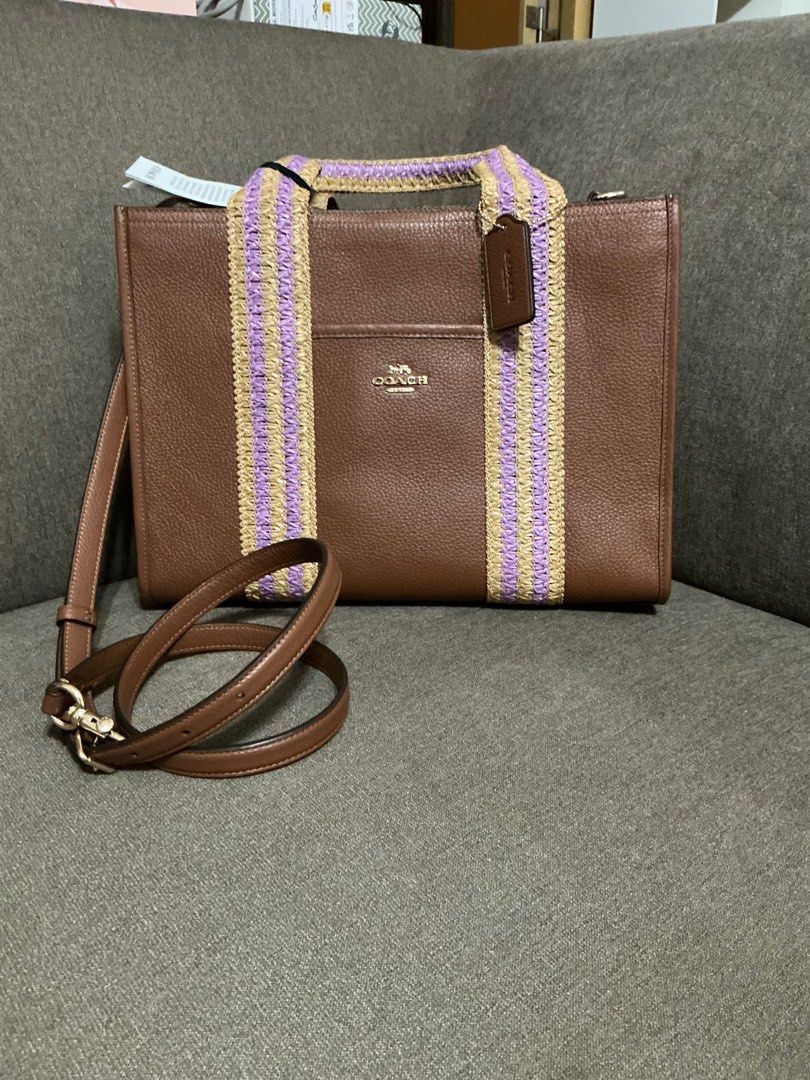 Coach Straw Webb Smith Tote - Medium (Category: Luxury Bags & Wallets) located in San Pedro. Submitted by misslumi (Listing ID 1385907708, Image 1). Description: Brand New from Canada!! - Medium size. - Redwood Multi color - Open tote with magnetic closure. - with slim leather crossbody strap. - Fits ipad pro 13" - Fits 13" laptops Style Number CBG90 Measurements Length: 13.5" Height: 10.0" Width: 5.0" Materials Refined pebble leather Handle Hand