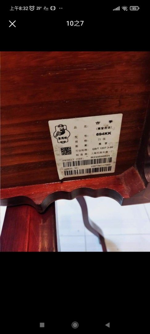 敦煌古箏 （分類：復古收藏品）位於 Hong Kong。 由 659888 提交（商品編號 1386106936，圖片 4）。簡介： 這是一把精美的古箏，木質結構，雕刻精美。琴身有文字雕刻，琴頭有裝飾。附帶琴架。琴身整體呈棕色，細節處有金色裝飾。琴身背面有標籤，標示了型號等信息。琴弦完整，適合演奏。。