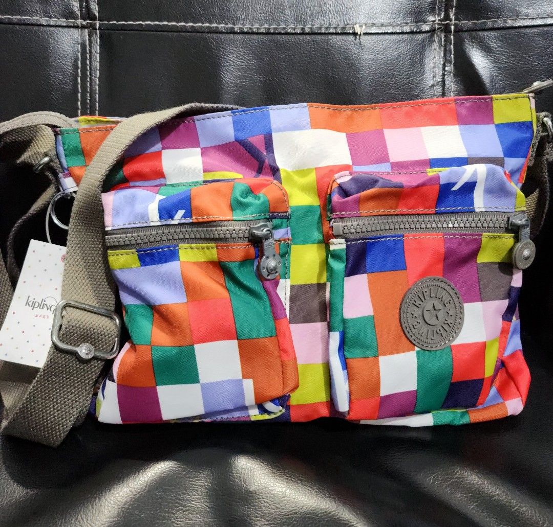 BNWT Kipling Coralie cross body bag (Category: Cross-body Bags) located in Quezon City. Submitted by ki_cai (Listing ID 1386190359, Image 1). Description: Brand New With Tag Kipling Bag Colorful checkered design Has been stored in the closet for years, never used Zippers are still smooth With 2 front pockets (zipper enclosure) 1 back pocket with magnetic enclosure Perfect for everyday use because of the pockets. No need for a bag organizer Flaw: 