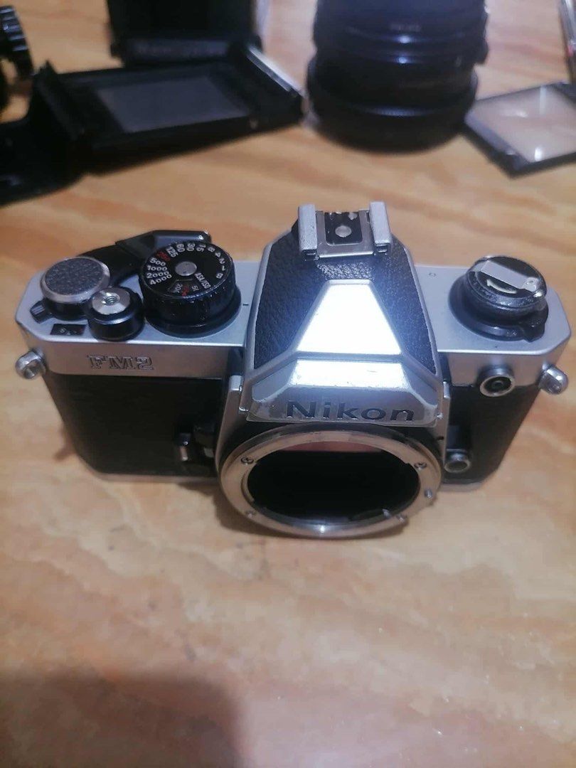 Nikon FM2 body (Category: Cameras) located in Manila. Submitted by dominicju40682 (Listing ID 1386160433, Image 2). Description: Nikon FM2 body in good condition Functions 9/10 Cosmetics 9/10 Recently CLAd by Sir Mike Coloma Touch up paint done, some scratches on the chrome body esp at the bottom plate. No corrosion on the battery compartment Shutter working, shutter speeds from bulb to 1/4000s working Light meter needs repair, LED light working,