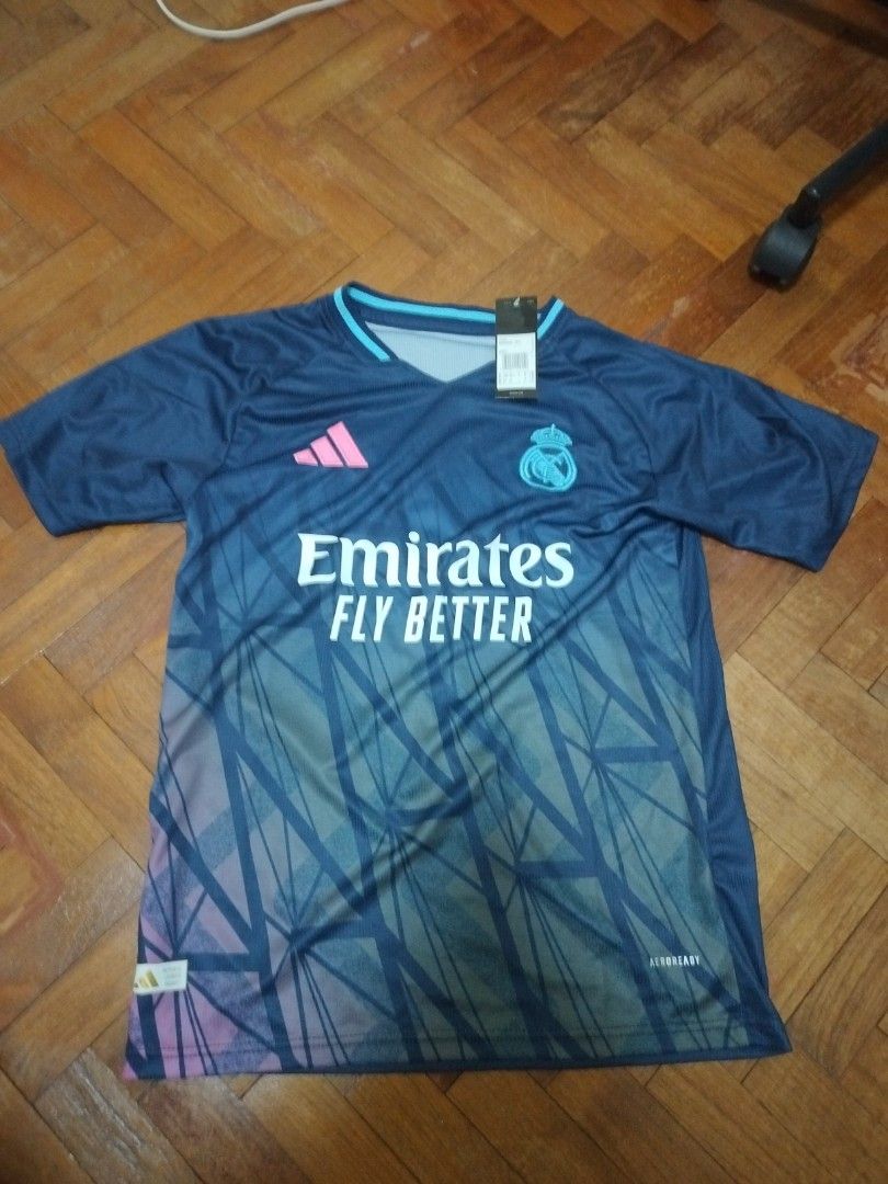 Real Madrid jersey (Category: Activewear) located in Singapore. Submitted by miwa. (Listing ID 1386170327, Image 1). Description: BNWT tracked postage with bubble mailer is $2 postage fee waived with minimum purchase of $30.
