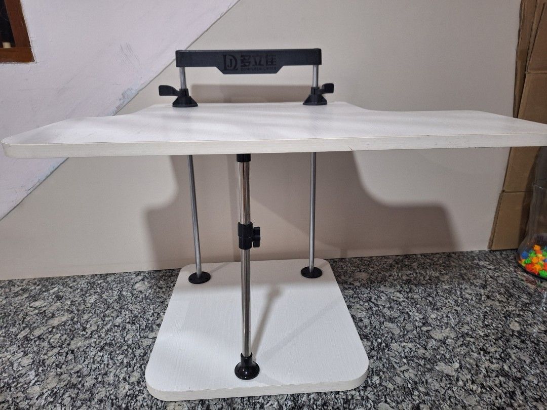 Adjustable Computer Table (Category: Tables & Sets) located in Singapore. Submitted by mini.bunnies (Listing ID 1386359868, Image 2). Description: - Excellent condition - Adjustable table - White tabletop - Sturdy frame - Ideal for laptop or small desk - Easy height adjustment.