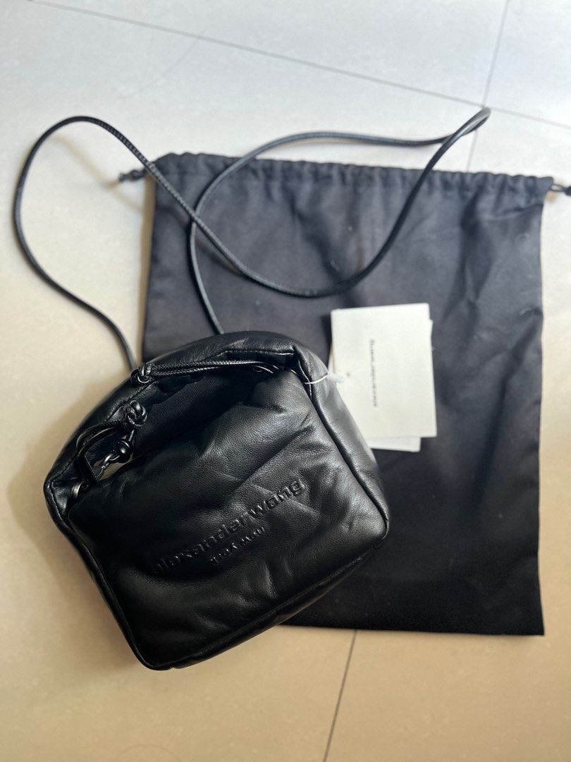 Alexander Wang Ryan Puff Mini Bag (Category: Luxury Bags & Wallets) located in Quezon City. Submitted by thirdy1 (Listing ID 1386212977, Image 2). Description: the mini ryan puff shoulder bag in black is a reinterpretation of the traditional dust bag silhouette—crafted in black lambskin leather. it features a tonal alexanderwang raised logo at the front, a fixed-length crossbody strap, plus a drawstring closure. detachable crossbody strap drawstr