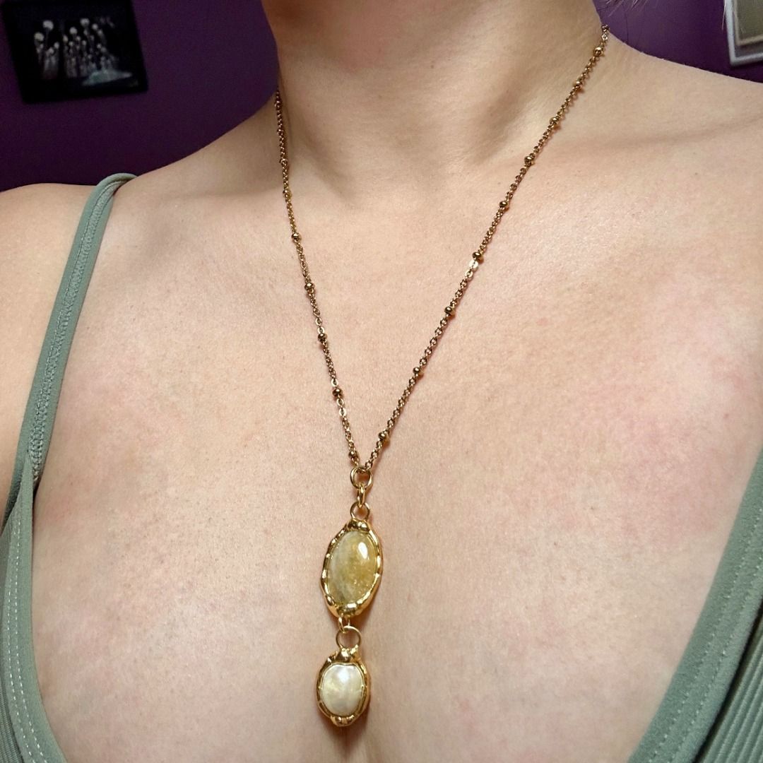 Gold Double Oval Pendant Necklace (Category: Necklaces) located in Quezon City. Submitted by martits (Listing ID 1386270538, Image 1). Description: Chic gold-tone necklace with two oval pendants (moonstone & pearl) on a delicate chain. Minimalist yet elegant. Dimensions: · Laid flat, chain is 9.5" · Pendant is 2" Used once only and newly purchased from Kultura. Original price is 2300!.