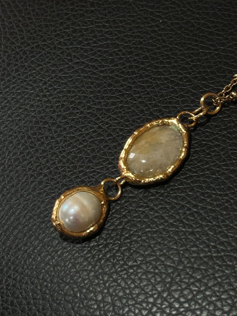 Gold Double Oval Pendant Necklace (Category: Necklaces) located in Quezon City. Submitted by martits (Listing ID 1386270538, Image 3). Description: Chic gold-tone necklace with two oval pendants (moonstone & pearl) on a delicate chain. Minimalist yet elegant. Dimensions: · Laid flat, chain is 9.5" · Pendant is 2" Used once only and newly purchased from Kultura. Original price is 2300!.