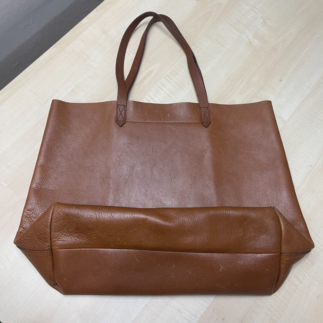 Madewell Brown Leather Tote Bag (Category: Tote Bags) located in Quezon City. Submitted by prelovedbygirliess (Listing ID 1386289005, Image 2). Description: Authentic Lightly used Has scratches but no other flaws 8/10 condition Has ""FBL"" engraving The Transport Tote Height: 13.75" Length: 18" Width: 6.5" Drop: 8.25".