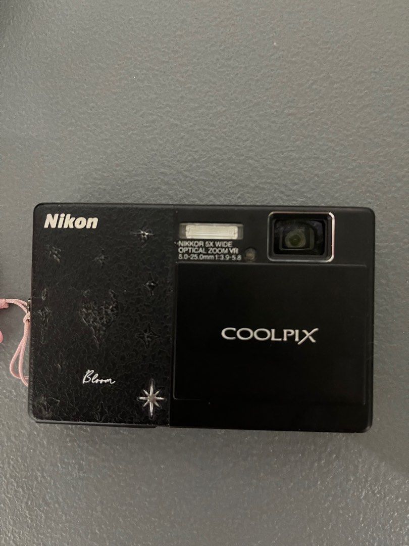 Nikon Coolpix S70 // digicam // digital camera (Category: Cameras) located in Quezon City. Submitted by hahawenx (Listing ID 1379236841, Image 3). Description: The Nikon Coolpix S70 is a compact digital camera known for its 3.5-inch OLED touch-screen display and stylish, slim design. It features a 12.1-megapixel sensor, a 5x optical zoom (28-140mm equivalent), and 720p HD video recording. The camera also incorporates Nikon’s Smart Portrait System