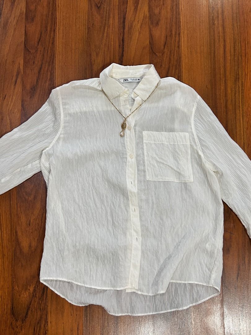 ZARA White Sheer Long Sleeve Button Down (Category: Blouses) located in Quezon City. Submitted by martits (Listing ID 1386276374, Image 2). Description: Used only once! Size small but oversized, can fit M as well! Super high quality fabric, kahit manipis, mukhang mamahalin Lightweight sheer white button-down shirt with chest pocket. Ideal for layering over camis or swimwear. Wear as a beach cover-up, or style with tailored pants for an airy offic