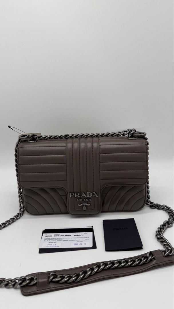 Authentic Prada diagramme flap (Category: Luxury Bags & Wallets) located in Quezon City. Submitted by jhaediah (Listing ID 1386587146, Image 1). Description: Prada diagramme flap etoupe color good condition with dustbag & card .