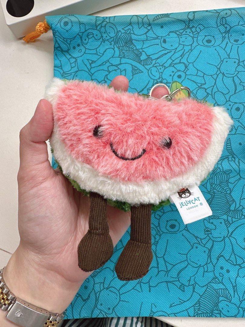 Bnew Original Jellycat Amuseable Watermelon Keychain Charm (Category: Plushies & Soft Toys) located in Davao. Submitted by misisnijungkook (Listing ID 1386520221, Image 1). Description: Bnew On hand and ready to Ship NO HAGGLING, Fixed price no last price - Bring a slice of joy to everyday life with the Jellycat Amuseable Watermelon Bag Charm Keyring! This adorable 3.5-inch fruit slice plush toy features a cheerful, smiling watermelon design, com