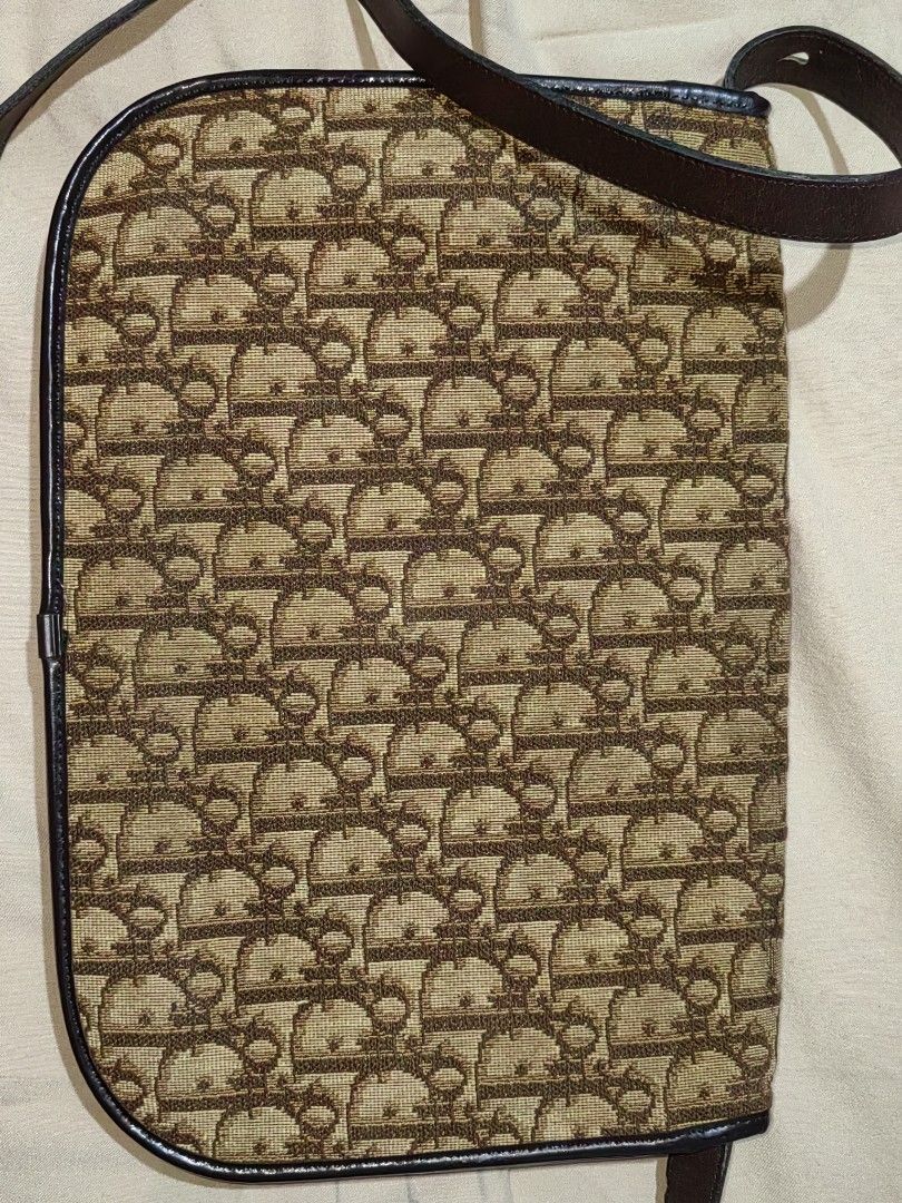 Authentic Christian Dior trotter shoulder bag (Category: Luxury Bags & Wallets) located in Donsol. Submitted by saksthriftavenuebyluckymaria8 (Listing ID 1386652639, Image 3). Description: Japan website selling this same bag for 50000 JPY 11in x 7.5in handle drop 17in excellent used condition * metal button closure can be closed and opened but bit loose *no holes no stains *corners are very fine * NO rubs *inside lining leather is intact no scuff