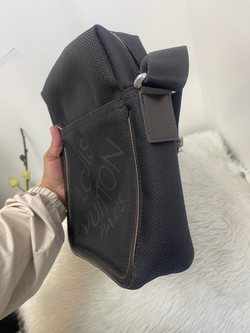 LOUIS VUITTON Black Damier Geant Citadin Messenger Bag (Category: Luxury Bags & Wallets) located in Taguig. Submitted by mluxeph (Listing ID 1386640204, Image 3). Description: LOUIS VUITTON Black Damier Geant Citadin Messenger Bag Gender: Men’s Material: Damier Geant polyamide and polyester jacquard canvas Stamp: SP0026 Year: 2006 Interior: One zipper compartment with Two open pockets Measurements: 8”L X 3.3”W X 10.5”H Handle Drop: 20.5” Hardware