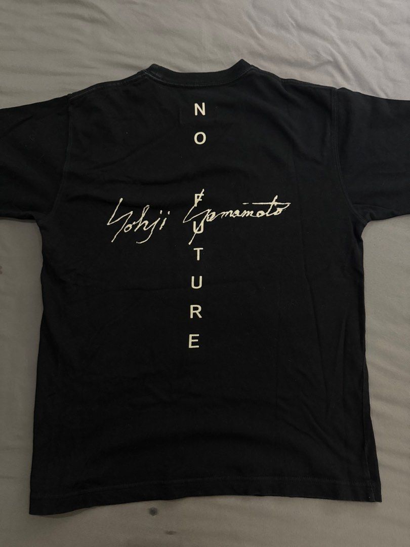 New Era x Yohji Yamamoto T-shirt - Small (Category: Tshirts & Polo Shirts) located in Singapore. Submitted by canshsm (Listing ID 1386639865, Image 1). Description: - Authentic/Not os - New Era x Yohji Yamamoto collaboration T-shirt - Black color - Size: Small - Features 'No Future' graphic on the back - New Era logo on sleeve - Perfect for fans!.