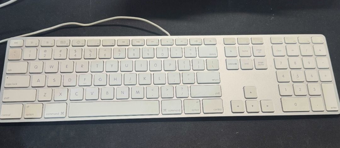 Apple Wired Aluminum Magic Keyboard A1243 – Full-Size with Numeric Keypad (Preloved) (Category: Computer Keyboard) located in Toledo. Submitted by xoxreina (Listing ID 1386908322, Image 1). Description: Selling an Apple Wired Aluminum Magic Keyboard (Model A1243) — the classic, durable keyboard with a sleek aluminum finish and built-in numeric keypad. Condition: Preloved, fully functional. Keys have a slight yellowish tint due to age, but this do