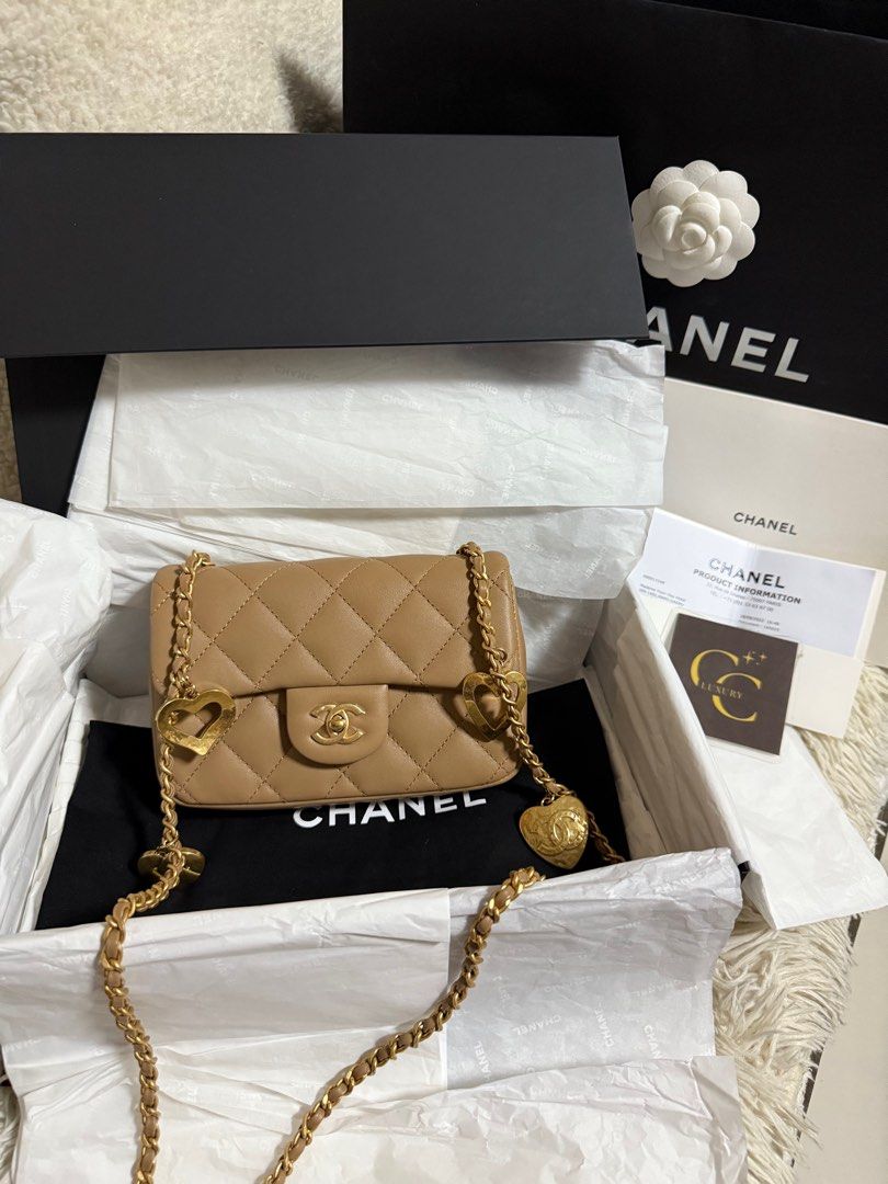 Chanel Mini Flap Dark Beige GHW (Category: Luxury Bags & Wallets) located in Manila. Submitted by ccluxuryy (Listing ID 1386833872, Image 2). Description: Chanel Mini Rec Heart Charms Flap in Caramel / Nude GHW Lambskin Leather Microchipped Excellent condition, no rubs, plastic film still intact Comes full box with gift receipt and authenticity certificate from legitgrails Retails for P360k 🥺 P235k only Location: Merville, Paranaque Meet up: MOA
