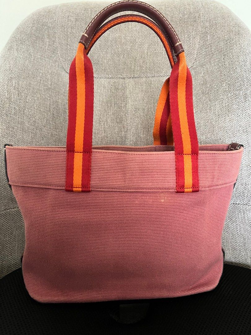 Coach Women's Small Canvas Tote Handbag (Light Raspberry Multi) (Category: Luxury Bags & Wallets) located in Quezon City. Submitted by spincart (Listing ID 1386794634, Image 2). Description: Canvas and smooth leather Inside zip pocket Snap closure Handles with 7” drop 9 1/4” (L) x 9” (H) x 4 1/4” (W) Designed to be small and lightweight, perfect for carrying your essentials. Convenient interior zippered pocket on the wall of the tote for storing 