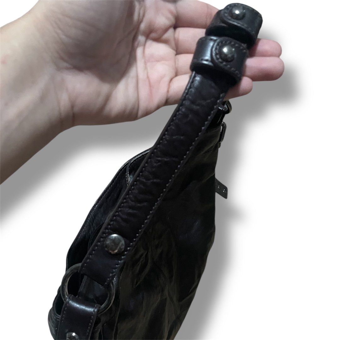 FIORUCCI crumpled leather shoulder bag/ kili bag (Category: Luxury Bags & Wallets) located in Bulacan. Submitted by theclosetsale.ph (Listing ID 1386830360, Image 2). Description: On SALE ! 📣📣📣 FIORUCCI shoulder bag in Deep chocolate. Genuine cowhide leather. Edgy-looking shoulder bag. Very versatile at it also looks like color black in photos (check last two photos). Silver hardwares and studs on the straps. Subtle logo on front. Metal plate 