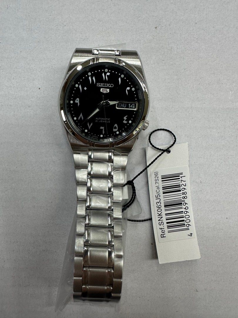 Seiko Arabic Dial SNK063J5 (Category: Luxury Watches) located in Manila. Submitted by seikowatchfactory (Listing ID 1386835851, Image 2). Description: Model: SNK063J5 Price: 7500 pesos Specifications: Case Size: 34mm Case Thickness: 12mm Case Material: Stainless Steel See Through Case Back Made in Japan Caliber 7S26 Automatic Movement 30m Water Resistance Luminous Hands and Markers Day/Date display White Arabic Numerals Transparent Caseback Hardl