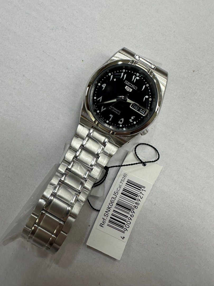 Seiko Arabic Dial SNK063J5 (Category: Luxury Watches) located in Manila. Submitted by seikowatchfactory (Listing ID 1386835851, Image 3). Description: Model: SNK063J5 Price: 7500 pesos Specifications: Case Size: 34mm Case Thickness: 12mm Case Material: Stainless Steel See Through Case Back Made in Japan Caliber 7S26 Automatic Movement 30m Water Resistance Luminous Hands and Markers Day/Date display White Arabic Numerals Transparent Caseback Hardl