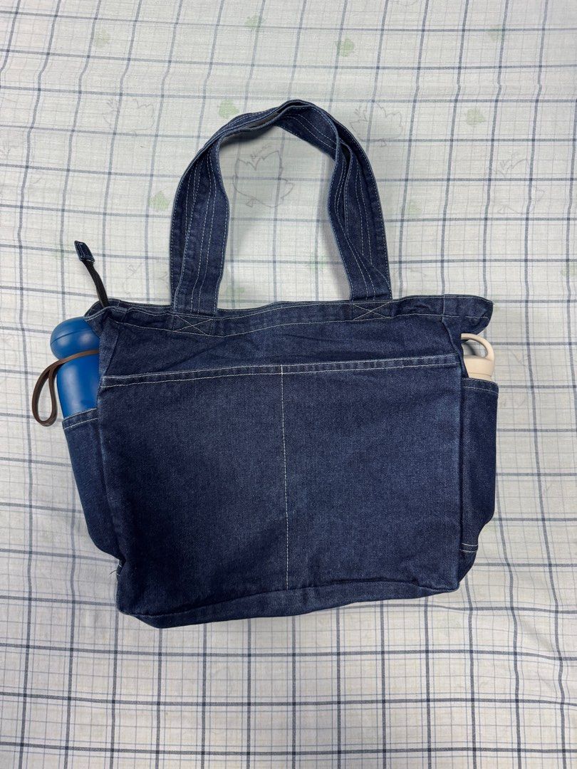 Denim Tote Bag (from Korea) (Category: Sling Bags) located in Quezon City. Submitted by __danmoi (Listing ID 1387020920, Image 2). Description: Got this Denim Tote bag from Korea. 4 exterior pockes, 1 inner pocket and a zip enclosure. Dimension: 14.5 inches Deep x 20 inches wide.