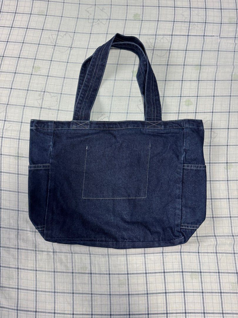 Denim Tote Bag (from Korea) (Category: Sling Bags) located in Quezon City. Submitted by __danmoi (Listing ID 1387020920, Image 3). Description: Got this Denim Tote bag from Korea. 4 exterior pockes, 1 inner pocket and a zip enclosure. Dimension: 14.5 inches Deep x 20 inches wide.